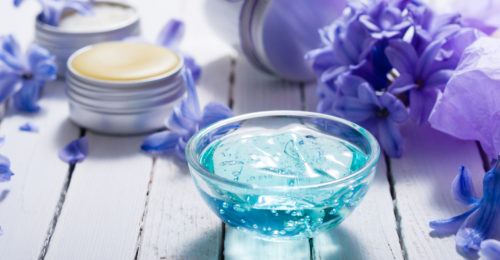 stock-photo-skin-care-product-samples-and-purple-hyacinth-flowers-on-white-wooden-1054820285